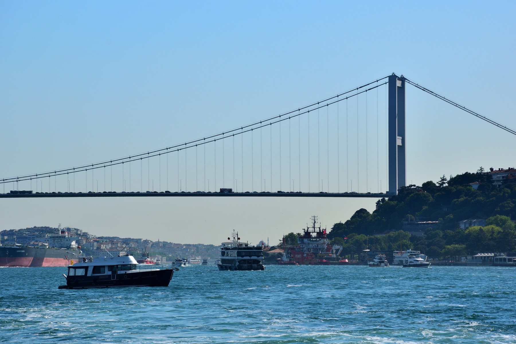 Boats on the Bosphorus with the bridge in the background, daytime